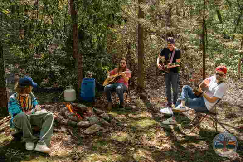 Americana musical jam in the forest at the Highlonesome Music Festival at Dockley Ranch near Chadwick Missouri in the Ozarks at an outdoor music festival for bluegrass and singer songwriter music. Justin Larkin Music performs